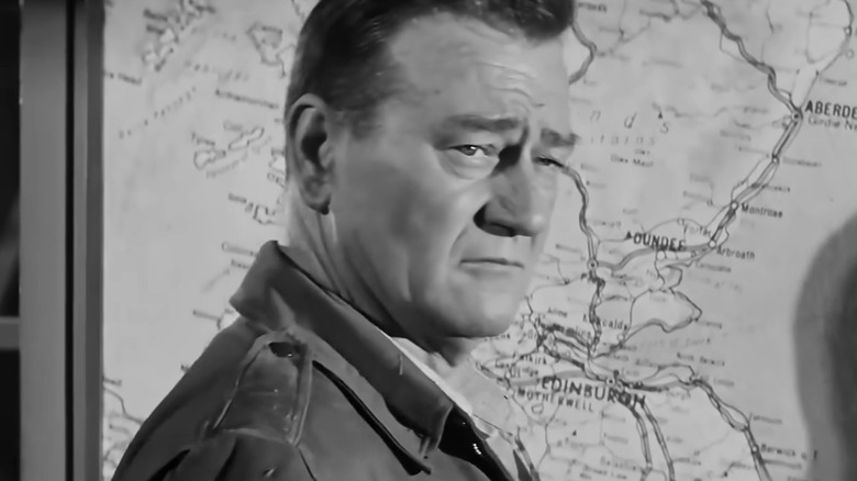 Lieutenant Col. Benjamin H. Vandervoort standing in front of a map in The Longest Day