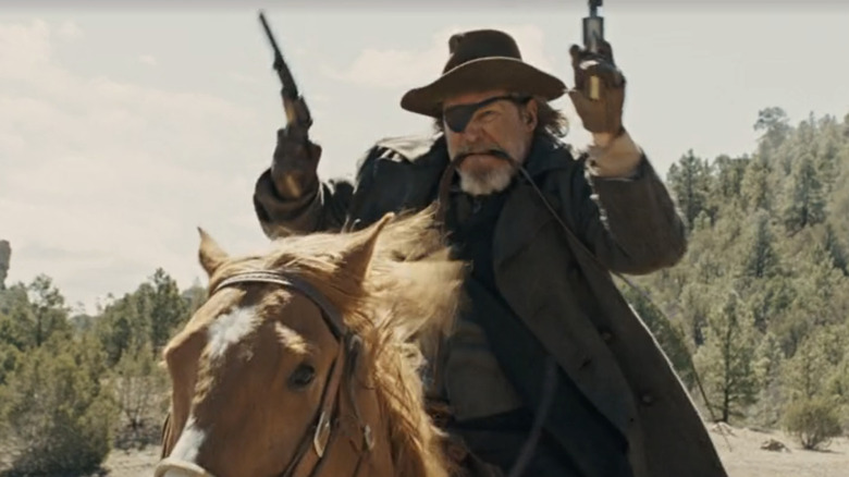 Rooster Cogburn riding on horseback with two guns in "True Grit" (2010)