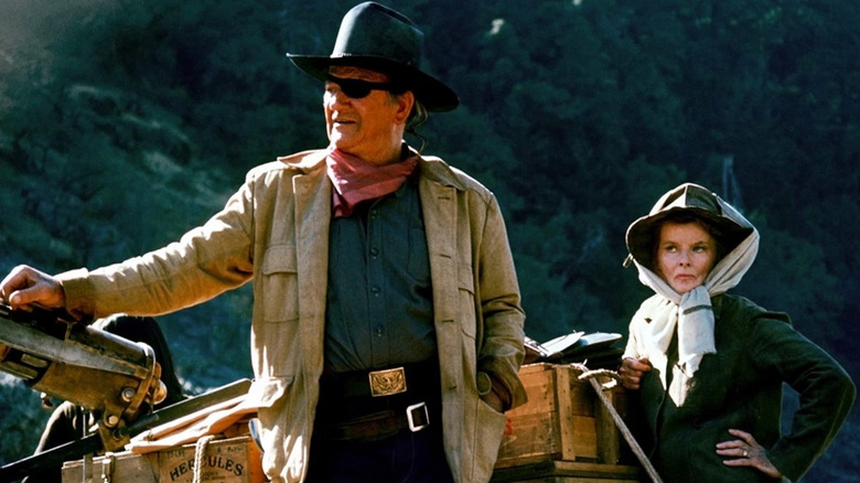 Rooster (John Wayne) standing next to Eula (Katherine Hepburn) in "Rooster Cogburn."