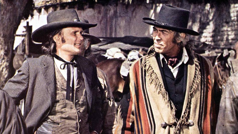 Billy the Kid and Pat Garrett walking outdoors in Pat Garrett and Billy the Kid