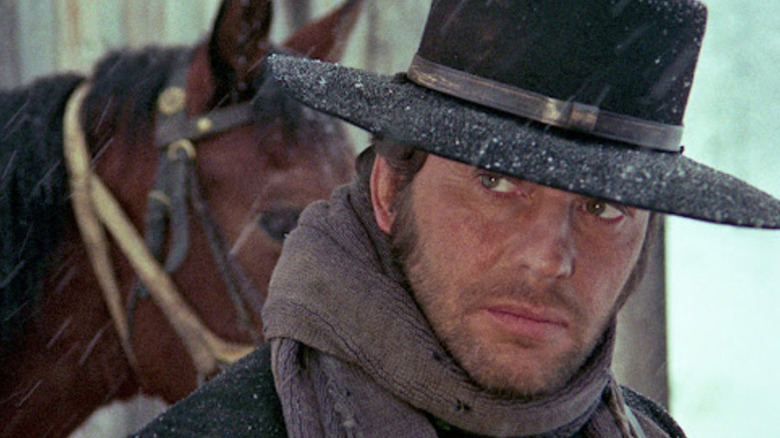 Silence (Jean-Louis Trintignant) standing in front of a horse in "The Great Silence."