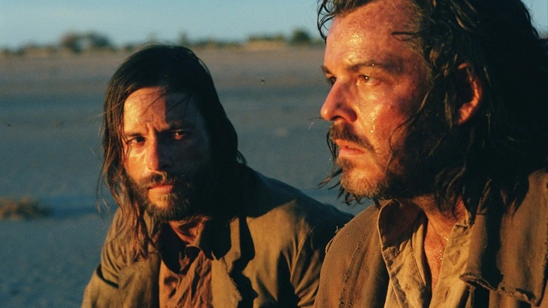 Charlie Burns looking over at a weary Arthur Burns in The Proposition (2005)