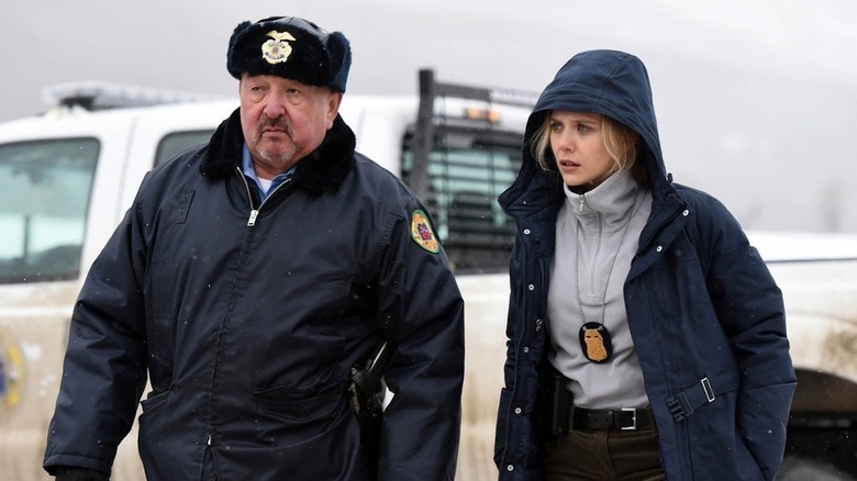 Ben Shoyo and Jane Banner standing beside a truck in Wind River