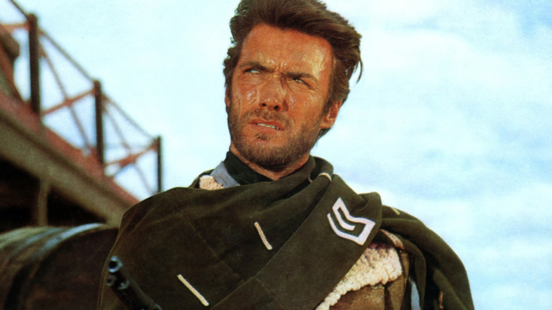 The Man with No Name scowling and pointing a gun off to the side in "A Fistful of Dollars" (1964)