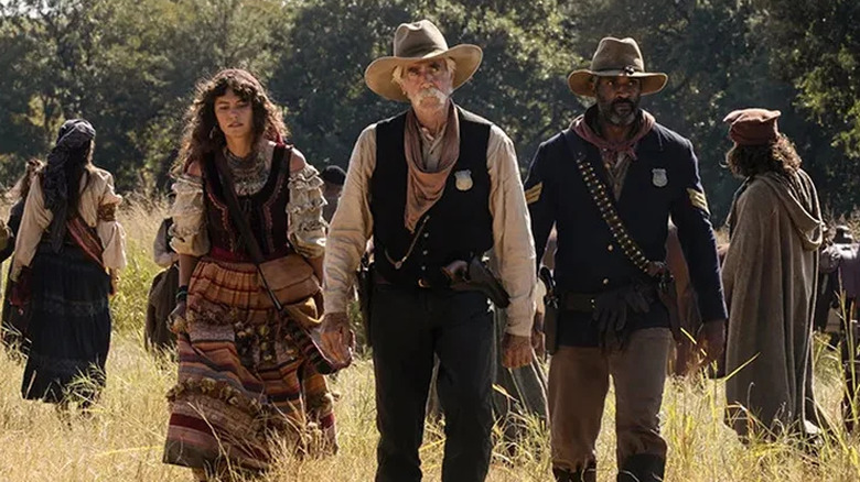 Shea Brennan, Thomas, and Noemi walk through the grass on 1883 (2021-2022)