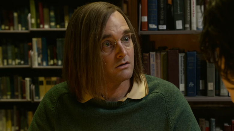 Douglas Kenney with books behind him in "A Futile and Stupid Gesture" (2018)