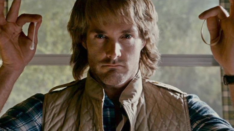 MacGruber holding a Q-tip and rubber band in 