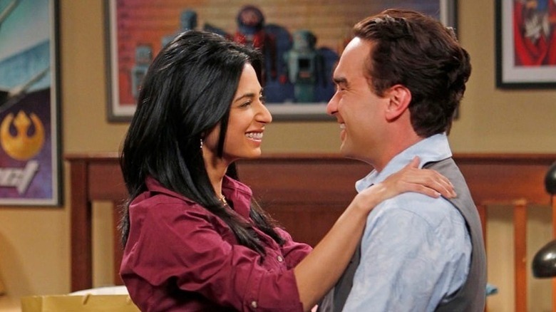 Priya and Leonard smiling at each other in a near embrace on The Big Bang Theory