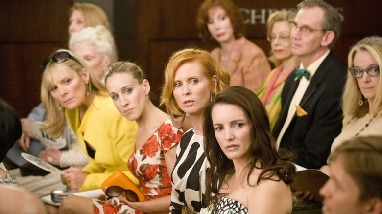 The leads of the Sex and the City turning around in shock at an auction in Sex and the City (2008)