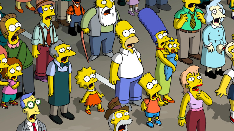 The Simpsons and denizens of Springfield looking up in shock in The Simpsons Movie (2007)
