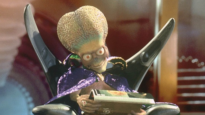 A Martian inspecting an Earth magazine in Mars Attacks! (1996)