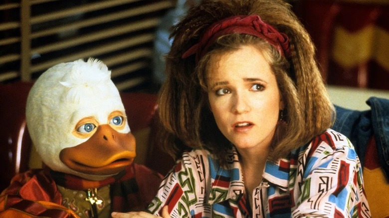 Howard and Beverly listening to a bizarre explanation in Howard the Duck (1986)