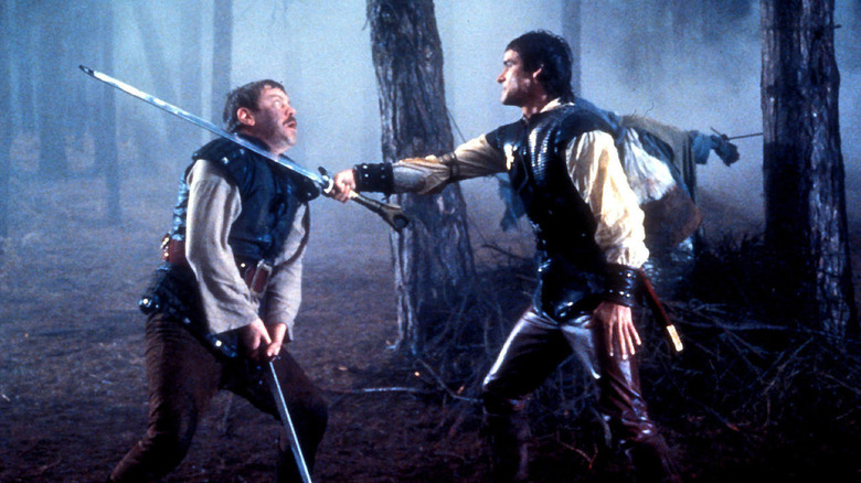 Hawk holds a sword to an enemy's throat in "Hawk the Slayer" (1980)