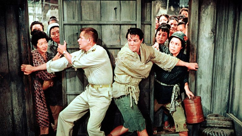 Sakini helping to keep the doors closed in The Teahouse of the August Moon (1956)