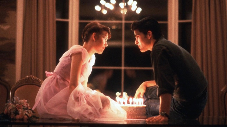Sam and Jake about to kiss over her birthday cake in Sixteen Candles