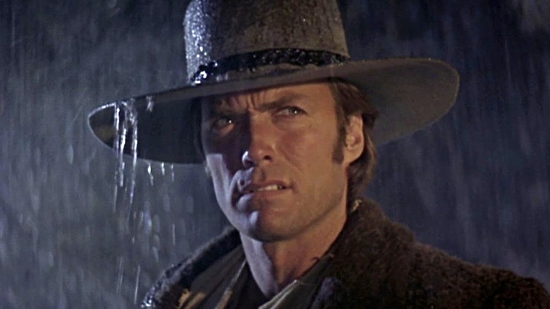 Pardner grimaces in the rain in 