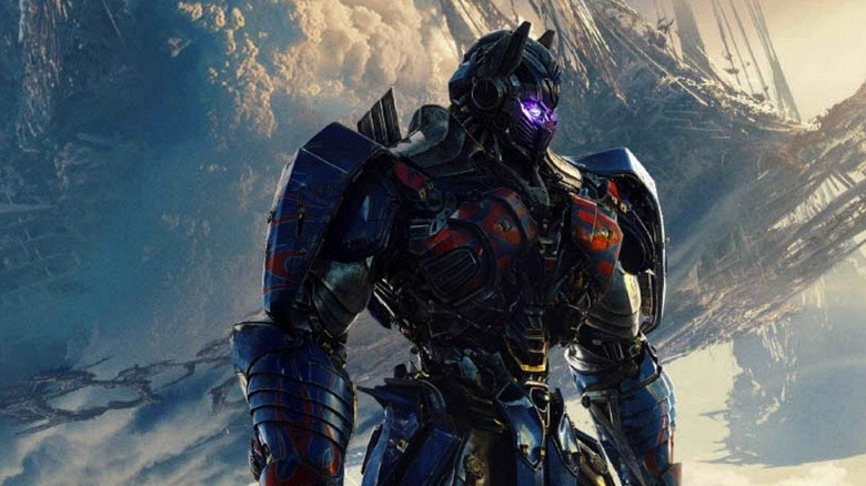 Optimus Prime stands among wreckage