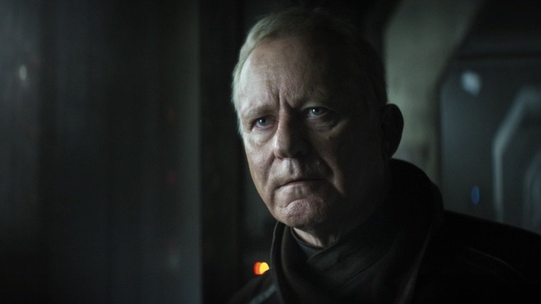 Luthen Rael delivers a tense monologue while standing in a shadowy corner of Coruscant in "Andor"