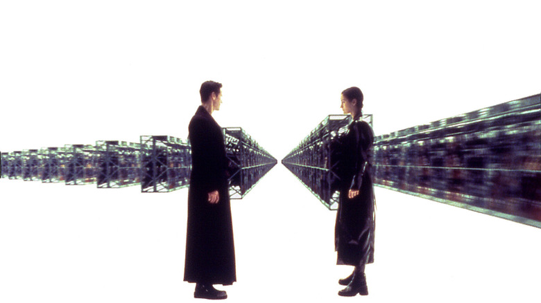 Neo and Trinity preparing to grab their weapons in The Matrix (1999)