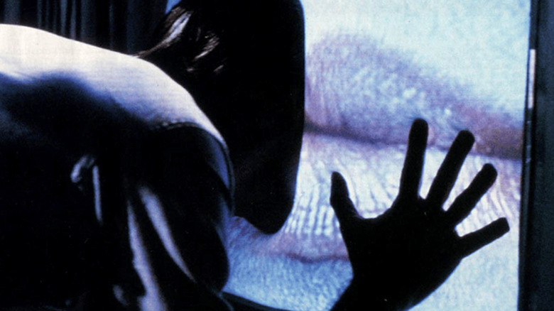 Max Renn getting absorbed by a TV in Videodrome (1983)
