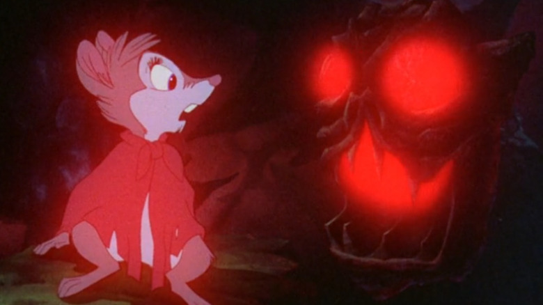 Mrs. Brisby looks at a glowing statue in The Secret of NIMH (1982)