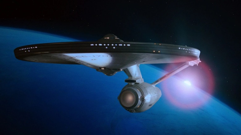 The USS Enterprise in orbit around a blue gas giant planet in 