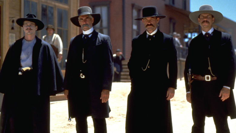 Doc Holliday, Virgil Earp, Wyatt Earp, and Morgan Earp standing together outside