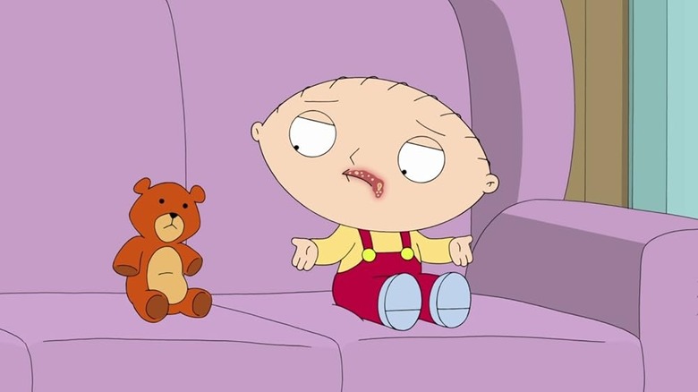 Stewie, with a cold sore on his face, talking to Rupert on the couch on "Family Guy"