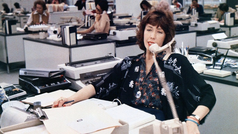Violet Newstead answering a call at her desk in 9 to 5 (1980)