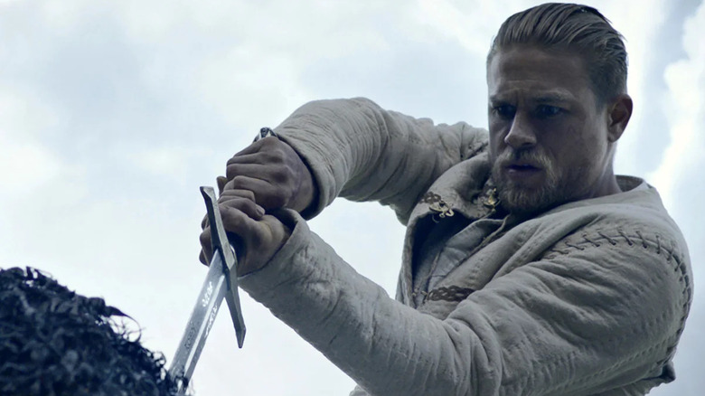 Arthur pulls the sword from the stone in King Arthur: Legend of the Sword (2017)