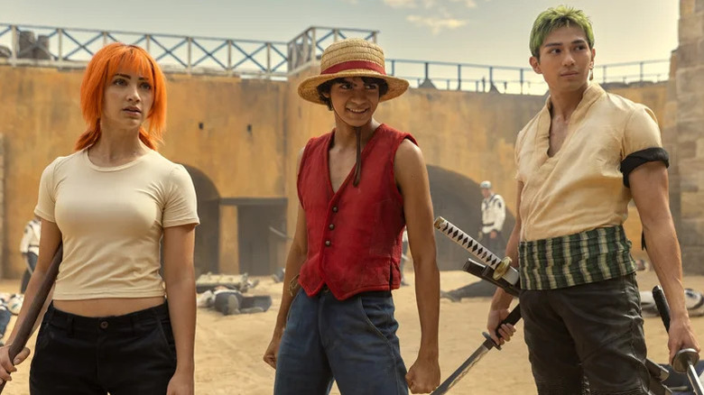 Nami, Monkey D. Luffy, and Roronoa Zoro standing together in One Piece