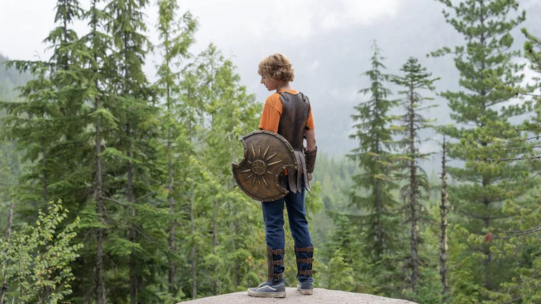 Percy Jackson holding a shield on Percy Jackson and the Olympians