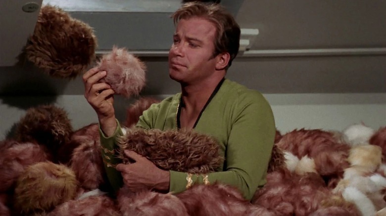 Captain Kirk sitting amidst a pile of Tribbles in "Star Trek"