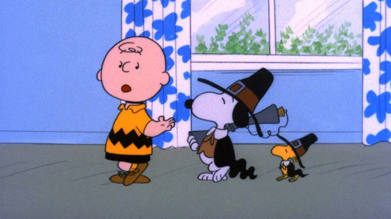 Charlie Brown talking to Snoopy and Woodstock in Thanksgiving outfits in A Charlie Brown Thanksgiving