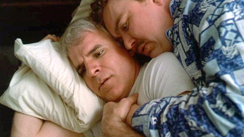 Del forcibly cuddling a distressed Neal in Planes, Trains and Automobiles