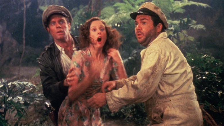 Jake Cutter, Corky, and Sarah huddling together in shock in Tales of the Gold Monkey