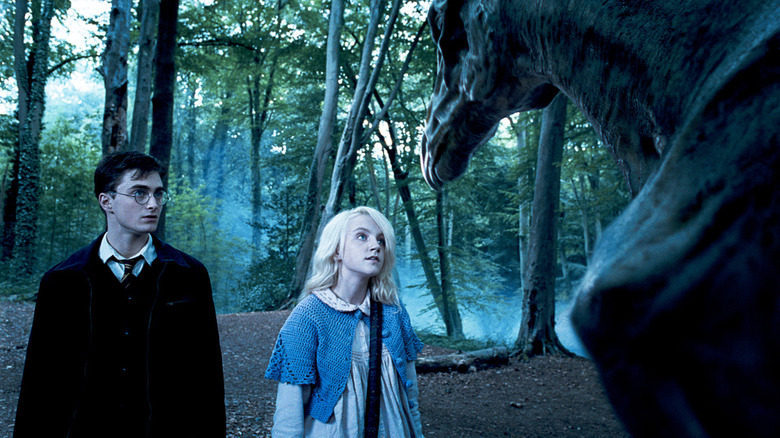 Ravenclaw student, Luna, introducing Harry to a thestral in the clear outskirts of the Forbidden Forest
