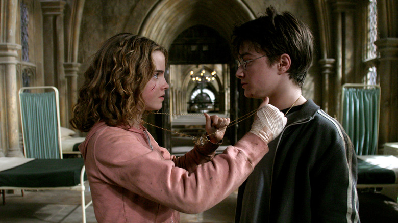 Hermione and Harry wearing the time turner around their necks in the Hogwarts infirmary