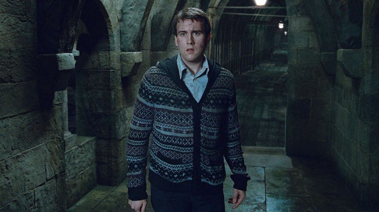 Neville standing in Hogwarts with dirt and blood on his head in Harry Potter and the Deathly Hallows