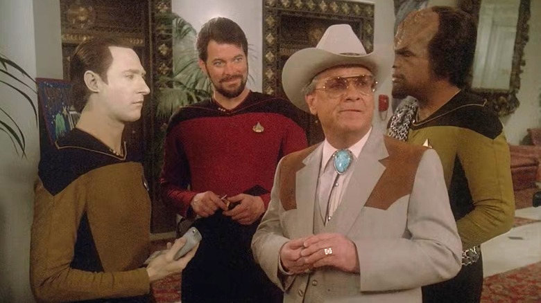 Data, Riker, and Worf look suspiciously at Texas in Star Trek: The Next Generation