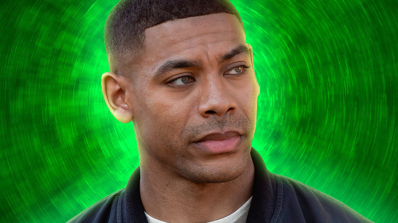 John Stewart looking skeptical with a green background