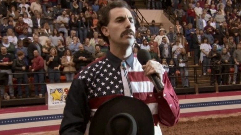 Borat singing a fake national anthem at a rodeo in Borat