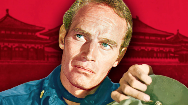 Major Matt Lewis in 55 Days at Peking looking stern against a red background