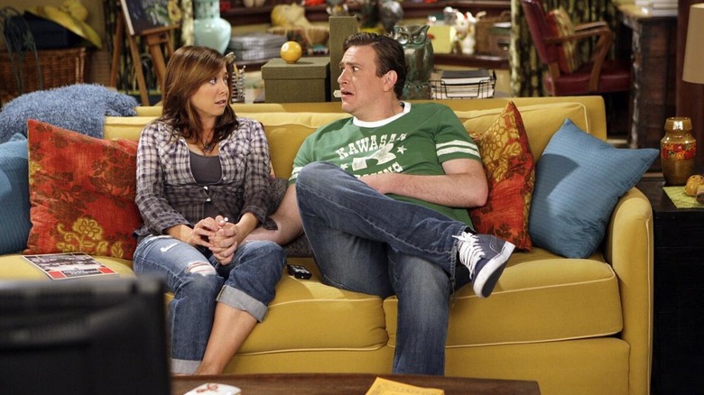 Lily Aldrin and Marshall Ericksen sit on the couch in "How I Met Your Mother"