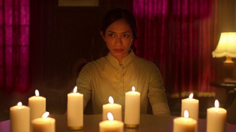 Sita surrounded by candles in Grave Torture (2024)