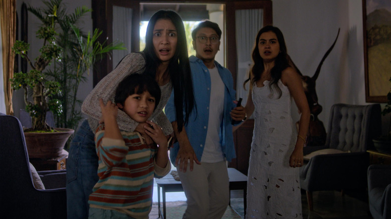 Kenes and her family look at the camera terrified in The Elixir (2025)