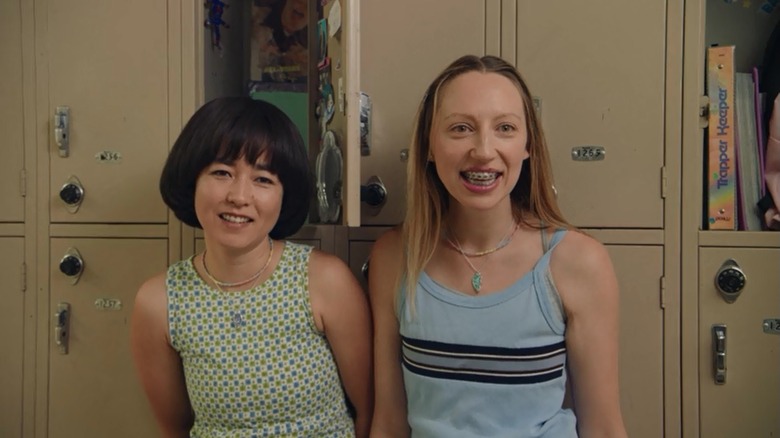 Maya and Anna smiling in front of their lockers on PEN15