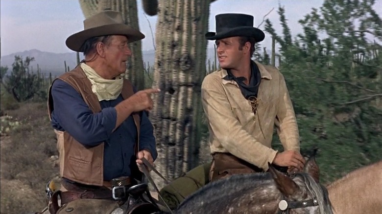 Cole (John Wayne) and Mississippi (James Caan) riding horses in "El Dorado."