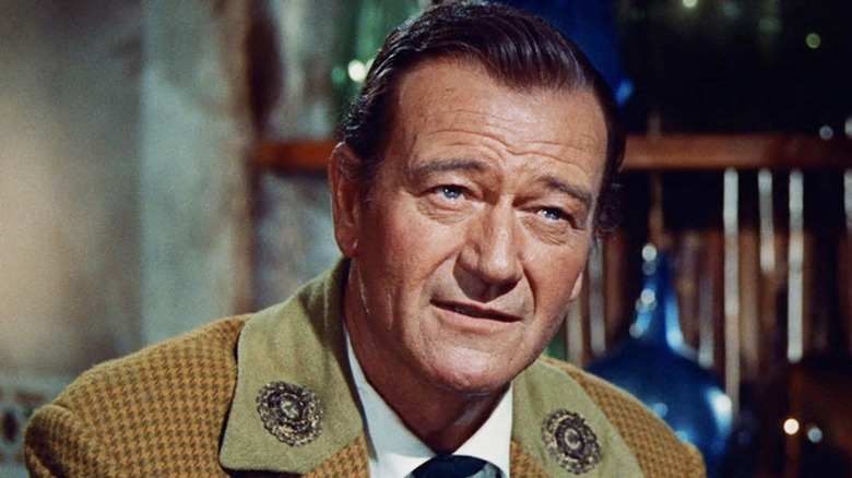 Davy Crockett (John Wayne) sitting down in "The Alamo."