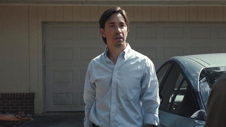 Gary standing next to his car in "Weapons" (2025)